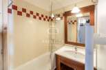 Discover a stylish bathroom featuring a sleek glass shower enclosure and a modern vanity.