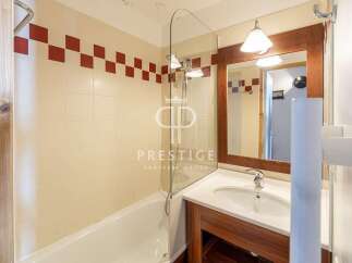 Discover a stylish bathroom featuring a sleek glass shower enclosure and a modern vanity.