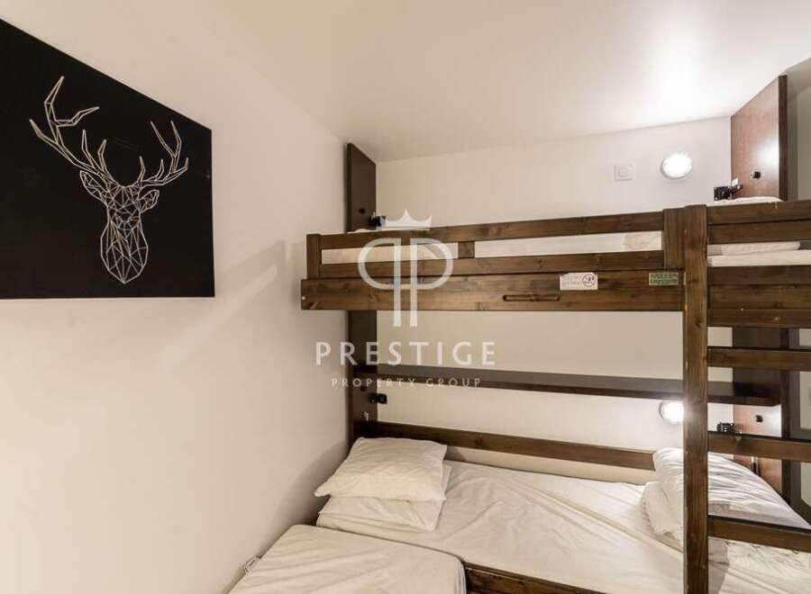 Cozy bunk beds offer a comfortable sleeping arrangement, perfect for families or groups.