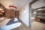 Experience luxury in this stunning property, featuring a beautifully designed bedroom with a cozy bed and stylish decor.