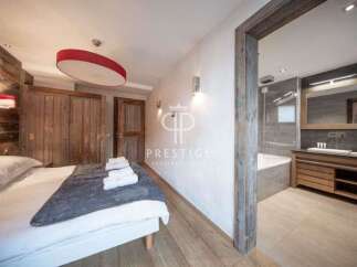 Experience luxury in this stunning property, featuring a beautifully designed bedroom with a cozy bed and stylish decor.