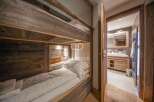Discover the charm of this cozy bedroom featuring custom-built bunk beds with rustic wooden accents.