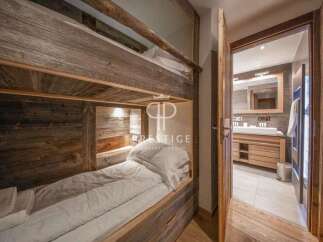 Discover the charm of this cozy bedroom featuring custom-built bunk beds with rustic wooden accents.