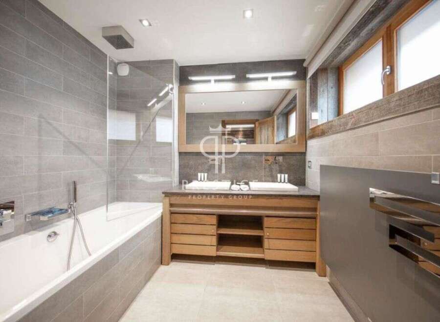 Discover luxury in this stunning bathroom, featuring a sleek design with modern fixtures.