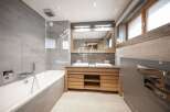 Discover luxury in this stunning bathroom, featuring a sleek design with modern fixtures.