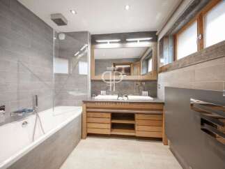 Discover luxury in this stunning bathroom, featuring a sleek design with modern fixtures.