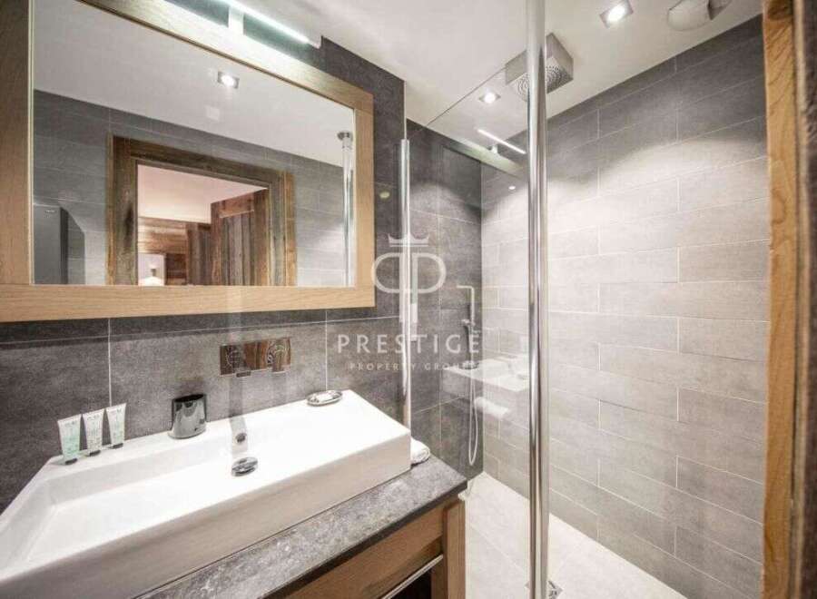 Discover luxury living in this stunning property! Featuring a modern bathroom with a sleek shower and a stylish sink, this space is designed for comfort and elegance.