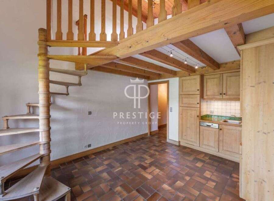 Discover a charming property featuring a unique spiral staircase and a cozy loft area.