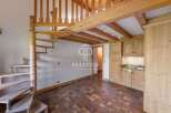 Discover a charming property featuring a unique spiral staircase and a cozy loft area.