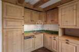 Discover the charm of this kitchen with its rustic wooden cabinets and cozy atmosphere.