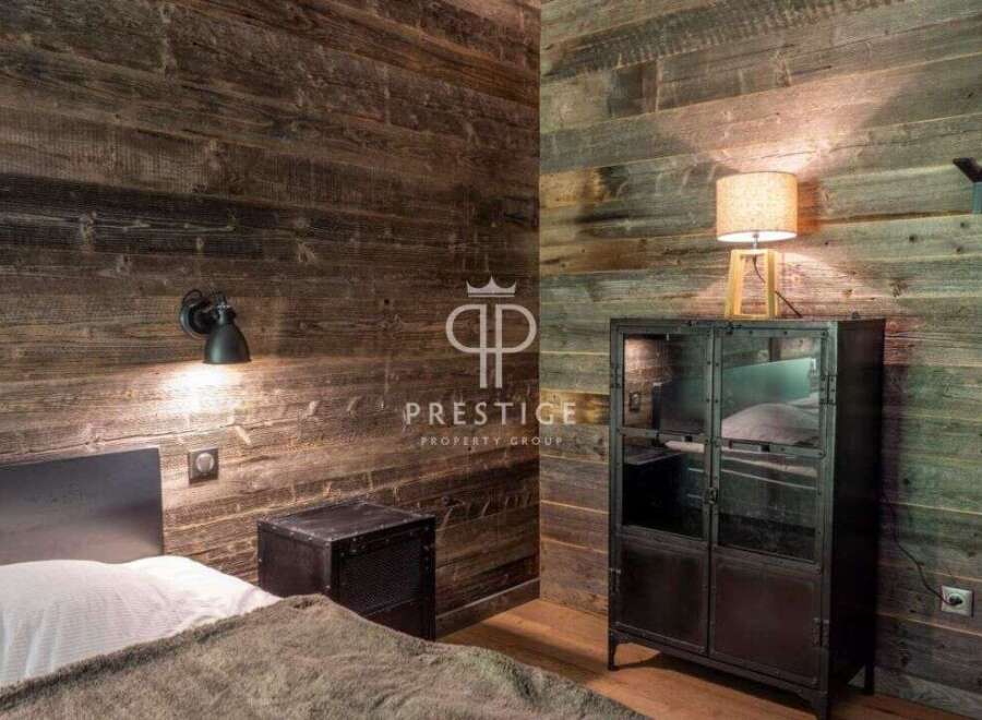 Experience rustic charm in this stunning bedroom featuring reclaimed wood walls.