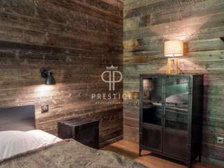 Experience rustic charm in this stunning bedroom featuring reclaimed wood walls.