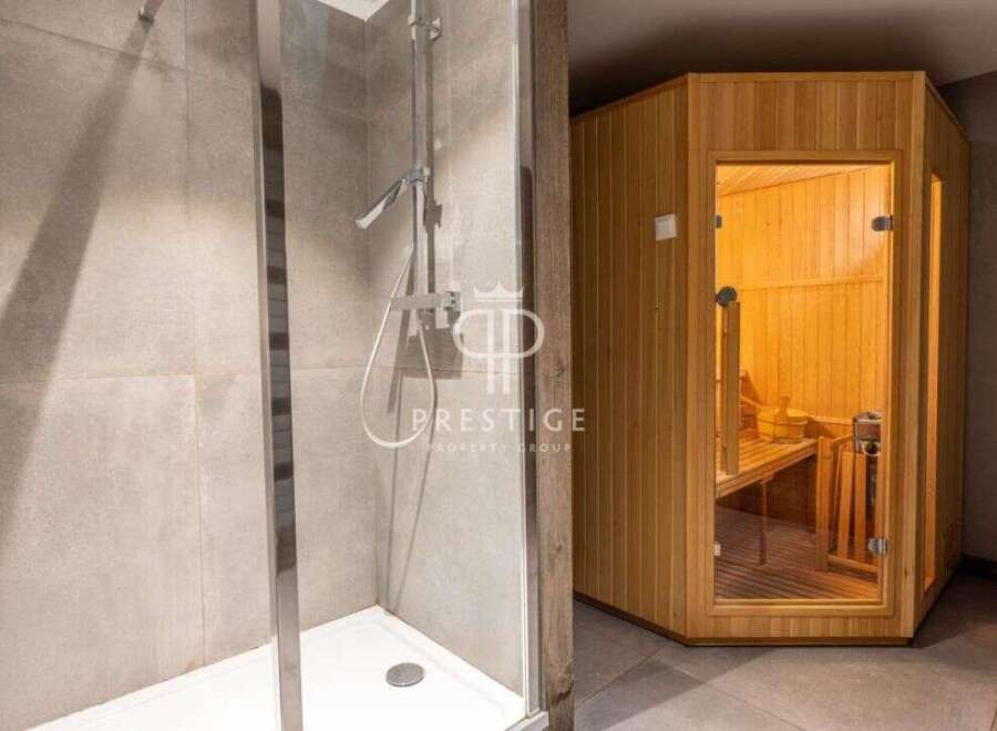 Discover luxury living with this stunning property featuring a modern shower and a relaxing sauna.
