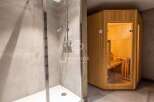 Discover luxury living with this stunning property featuring a modern shower and a relaxing sauna.