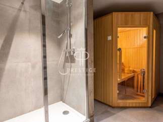 Discover luxury living with this stunning property featuring a modern shower and a relaxing sauna.