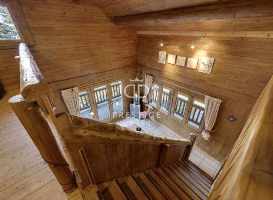 Discover the charm of this stunning wooden cabin, featuring a unique staircase design.