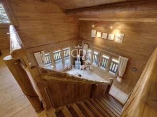 Discover the charm of this stunning wooden cabin, featuring a unique staircase design.