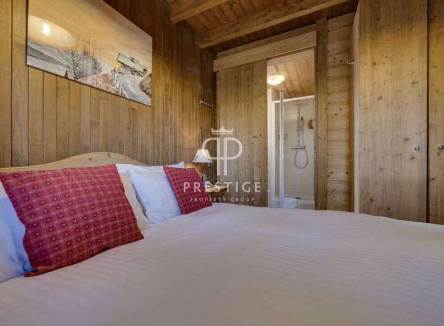Experience the charm of this cozy bedroom, featuring warm wooden accents and a serene ambiance.