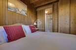 Experience the charm of this cozy bedroom, featuring warm wooden accents and a serene ambiance.