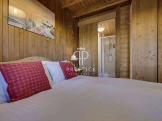 Experience the charm of this cozy bedroom, featuring warm wooden accents and a serene ambiance.