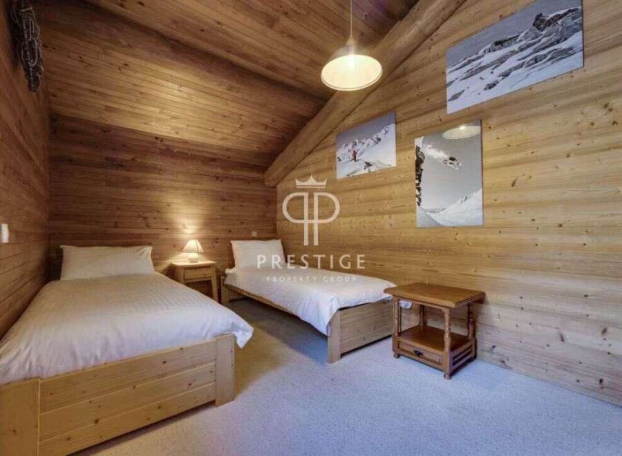 This cozy bedroom features a rustic wooden design, creating a warm and inviting atmosphere.