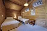This cozy bedroom features a rustic wooden design, creating a warm and inviting atmosphere.