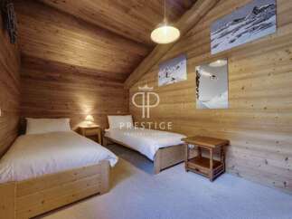 This cozy bedroom features a rustic wooden design, creating a warm and inviting atmosphere.
