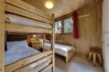Cozy bedroom featuring wooden bunk beds, perfect for a family or group.