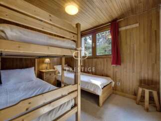 Cozy bedroom featuring wooden bunk beds, perfect for a family or group.