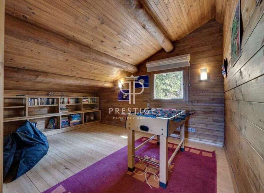 Discover the charm of this cozy attic space, featuring a rustic wooden interior.