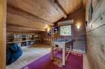 Discover the charm of this cozy attic space, featuring a rustic wooden interior.