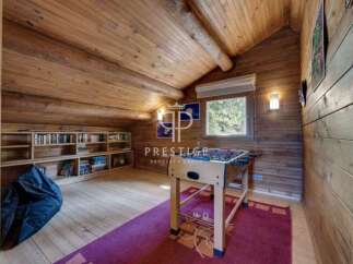 Discover the charm of this cozy attic space, featuring a rustic wooden interior.