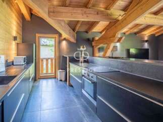 Discover the charm of this stunning kitchen, featuring exposed wooden beams and a modern design.