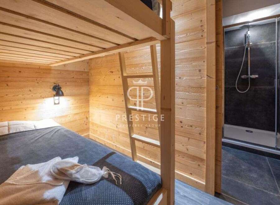 Discover a cozy bedroom featuring a bunk bed with wooden accents, perfect for a comfortable stay.