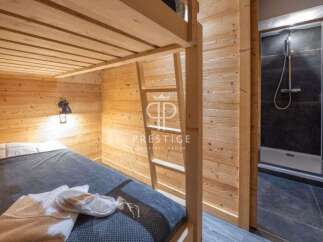 Discover a cozy bedroom featuring a bunk bed with wooden accents, perfect for a comfortable stay.