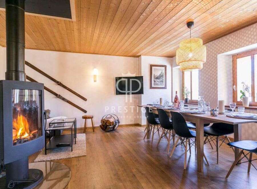 Experience rustic charm in this stunning property, featuring a cozy fireplace and a warm wooden ceiling.