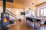 Experience rustic charm in this stunning property, featuring a cozy fireplace and a warm wooden ceiling.