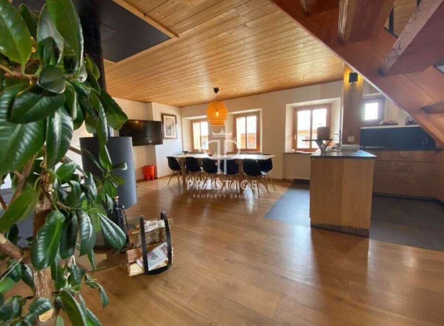 Discover the charm of this stunning property, featuring a warm and inviting interior with wooden floors and ceilings.