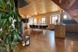 Discover the charm of this stunning property, featuring a warm and inviting interior with wooden floors and ceilings.