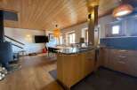 Discover the charm of this stunning property, featuring a warm wooden ceiling and flooring that exudes a cozy ambiance.