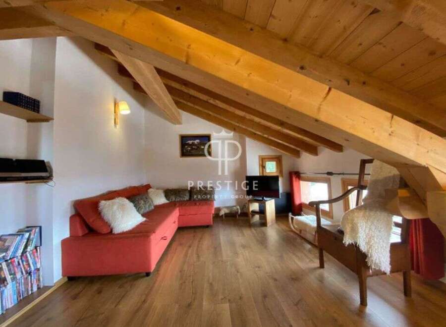 Discover the charm of this stunning property, featuring a cozy living area with a vibrant red sofa.