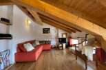 Discover the charm of this stunning property, featuring a cozy living area with a vibrant red sofa.