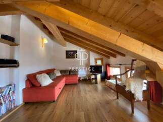 Discover the charm of this stunning property, featuring a cozy living area with a vibrant red sofa.