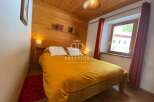 Cozy bedroom with wooden accents and a warm ambiance.
