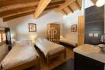Discover a charming bedroom featuring a cozy wooden bed frame and a warm, inviting atmosphere.