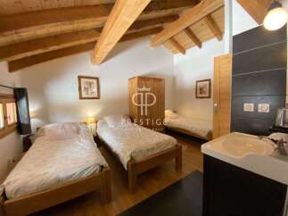 Discover a charming bedroom featuring a cozy wooden bed frame and a warm, inviting atmosphere.