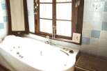 Relax and unwind in this luxurious bathroom featuring a modern jacuzzi tub.