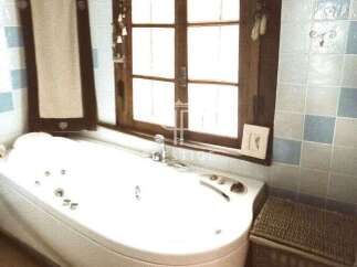Relax and unwind in this luxurious bathroom featuring a modern jacuzzi tub.