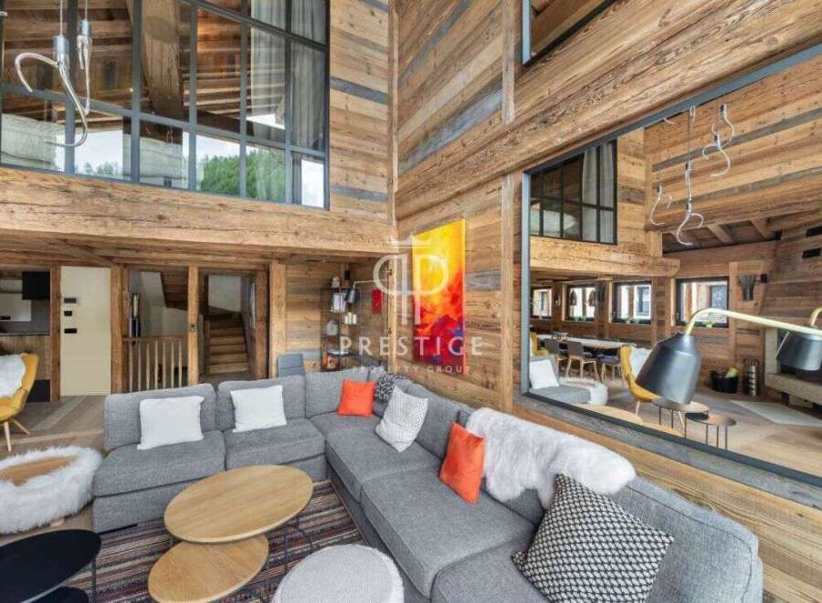 Experience luxury living in this stunning chalet, featuring a spacious living area with a cozy fireplace.