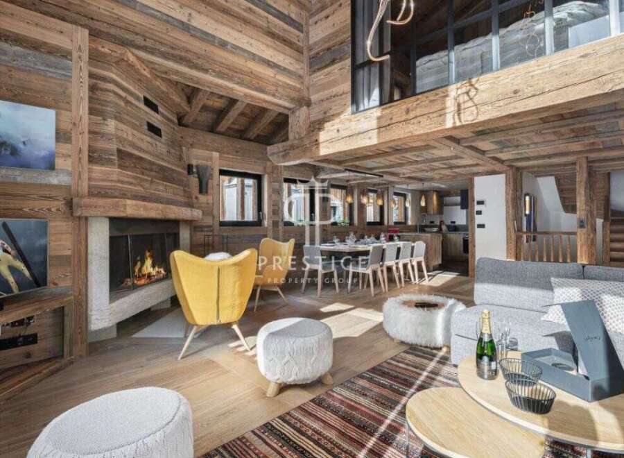 Experience luxury living in this stunning chalet, featuring a cozy fireplace and elegant wooden accents throughout.